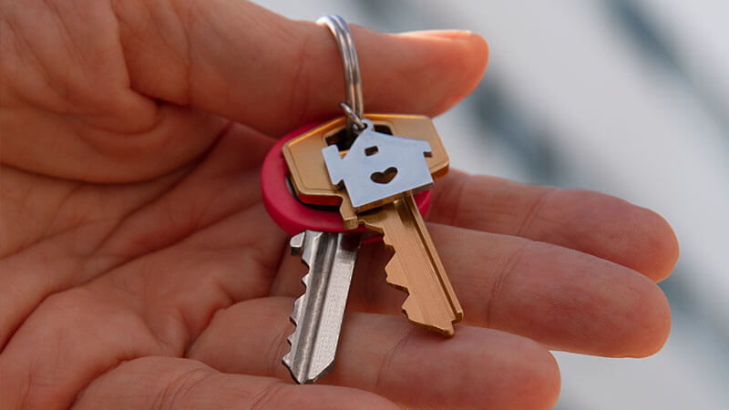 hand holding new home keys